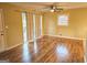 Bright living room featuring hardwood floors, large windows, and a ceiling fan at 655 Shellnut Dr, Forest Park, GA 30297