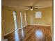 Bright living room with hardwood floors, ceiling fan, and sliding glass doors at 655 Shellnut Dr, Forest Park, GA 30297