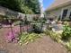Lush backyard with a charming bridge, a stone patio, and colorful flowers. Enjoy the beauty of nature at 221 Turtle Cv, Carrollton, GA 30116