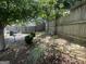 Shady backyard featuring a grill and rock bed, and a wooden privacy fence at 221 Turtle Cv, Carrollton, GA 30116