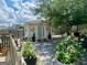 Garden shed amongst the trees with a gravel yard, and butterfly decorations at 221 Turtle Cv, Carrollton, GA 30116