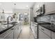 Modern kitchen with stainless steel appliances, granite countertops, and access to the outdoor balcony at 383 Pratt Dr # 506, Atlanta, GA 30315