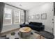 Bright living room with large windows, modern decor, and a comfortable seating area at 383 Pratt Dr # 506, Atlanta, GA 30315