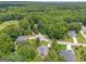Aerial view of a home nestled in a wooded lot, with a golf course nearby at 119 Creekside Vw, Hiram, GA 30141