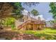 Landscaped backyard with a multi-level deck, ideal for outdoor dining and entertaining at 119 Creekside Vw, Hiram, GA 30141