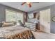 Comfortable bedroom with a ceiling fan, natural light, and ample storage space at 119 Creekside Vw, Hiram, GA 30141