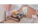 Cozy bedroom features dormered ceiling, carpet, window, and whimsical decor at 119 Creekside Vw, Hiram, GA 30141