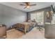 Cozy bedroom with a neutral color scheme, a ceiling fan, and a large window offering natural light at 119 Creekside Vw, Hiram, GA 30141