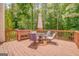 Outdoor wooden deck with table, chairs, and umbrella, offering a cozy seating area at 119 Creekside Vw, Hiram, GA 30141