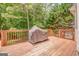 Covered grill on a wooden deck, creating a functional and inviting outdoor cooking space at 119 Creekside Vw, Hiram, GA 30141