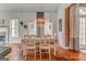 Light-filled dining room with hardwood floors, large windows, and views of the fireplace at 119 Creekside Vw, Hiram, GA 30141