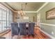 Elegant dining room featuring hardwood floors, decorative lighting, and ample seating for memorable gatherings at 119 Creekside Vw, Hiram, GA 30141