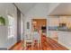 Dining room with hardwood floors, a view into the kitchen, and a modern chandelier overhead at 119 Creekside Vw, Hiram, GA 30141