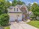 Charming two-story home with a stone facade, two car garage and a well-manicured lawn at 119 Creekside Vw, Hiram, GA 30141