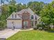 Charming two-story home with a stone facade and a well-manicured lawn at 119 Creekside Vw, Hiram, GA 30141