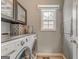 Functional laundry room with modern washer and dryer, ample counter space, and natural light at 119 Creekside Vw, Hiram, GA 30141