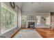 Spacious living room with hardwood floors, a fireplace, and large windows offering scenic views at 119 Creekside Vw, Hiram, GA 30141