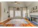 Bright living room with a fireplace, hardwood floors, and a large window for ample natural light at 119 Creekside Vw, Hiram, GA 30141