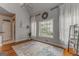 Inviting living room with hardwood floors, fireplace, and large windows providing natural light and backyard views at 119 Creekside Vw, Hiram, GA 30141