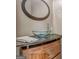 Unique powder room featuring a vessel sink, custom vanity, and stylish round mirror at 119 Creekside Vw, Hiram, GA 30141