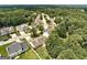 A serene residential street is captured from above, lined with mature trees for a tranquil community feel at 2898 Cedar Trace Dr, Ellenwood, GA 30294