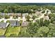 An aerial view of a quaint neighborhood with lovely homes, manicured lawns, and mature trees at 2898 Cedar Trace Dr, Ellenwood, GA 30294