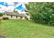 Backyard with a few mature trees and green lawn at 2898 Cedar Trace Dr, Ellenwood, GA 30294