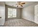 Bedroom features neutral walls, carpet, a ceiling fan, a window, and a white door at 2898 Cedar Trace Dr, Ellenwood, GA 30294