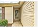 Home entrance featuring vinyl siding, a glass door, and a small shrub, set in a residential location at 2898 Cedar Trace Dr, Ellenwood, GA 30294