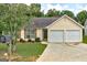 Charming single-story home with a two-car garage, well-maintained lawn, and mature landscaping at 2898 Cedar Trace Dr, Ellenwood, GA 30294