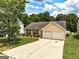 Charming single-Gathering home with two-car garage and well-manicured front yard at 2898 Cedar Trace Dr, Ellenwood, GA 30294