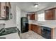 Kitchen showcasing black appliances, dark wood cabinets, and plenty of natural light at 2898 Cedar Trace Dr, Ellenwood, GA 30294