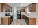 Kitchen featuring dark cabinets, black appliances, and lots of space at 2898 Cedar Trace Dr, Ellenwood, GA 30294