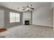 Cozy living room with a fireplace, carpet, and a bright window at 2898 Cedar Trace Dr, Ellenwood, GA 30294