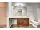 Neutral bathroom features a wooden vanity, large mirror, lighting, toilet and doorway to bedroom at 2898 Cedar Trace Dr, Ellenwood, GA 30294