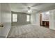 Spacious main bedroom features neutral walls, carpet, ceiling fan, and en suite bathroom and walk in closet at 2898 Cedar Trace Dr, Ellenwood, GA 30294