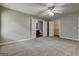 Spacious main bedroom features neutral walls, carpet, ceiling fan, and en suite bathroom and walk in closet at 2898 Cedar Trace Dr, Ellenwood, GA 30294