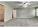 Spacious main bedroom features neutral walls, carpet, ceiling fan, and doorway to bathroom and walk-in closet at 2898 Cedar Trace Dr, Ellenwood, GA 30294