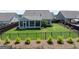 Aerial view of the fenced backyard featuring a screened-in porch, plants, and grass at 4160 Grandview Vista St, Cumming, GA 30028