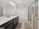 Bright bathroom with double sink vanity, framed mirror, and a glass-enclosed walk-in shower at 4160 Grandview Vista St, Cumming, GA 30028
