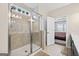 Glass enclosed walk-in shower in the bathroom with tile surround and view into the bedroom at 4160 Grandview Vista St, Cumming, GA 30028