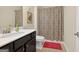 Bathroom featuring patterned shower curtain, a decorative mirror, and ample counter space at 4160 Grandview Vista St, Cumming, GA 30028