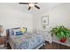 Cozy bedroom with large window, ceiling fan, wood flooring, and stylish decor at 4160 Grandview Vista St, Cumming, GA 30028