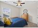 Well-lit bedroom with a ceiling fan and a window overlooking outside at 4160 Grandview Vista St, Cumming, GA 30028