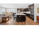 Open kitchen with a large island, dark cabinetry, modern appliances, and adjacent dining area at 4160 Grandview Vista St, Cumming, GA 30028