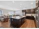 Open kitchen features dark cabinetry, granite countertops, and stainless steel appliances at 4160 Grandview Vista St, Cumming, GA 30028