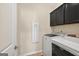 This laundry room features cabinetry, a washer, and a dryer at 4160 Grandview Vista St, Cumming, GA 30028