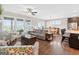 Bright living area with fireplace, hardwood floors, large windows, and access to dining room at 4160 Grandview Vista St, Cumming, GA 30028