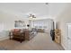 Spacious living room with a ceiling fan, carpet floors, and lots of windows at 4160 Grandview Vista St, Cumming, GA 30028