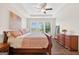 Spacious main bedroom with hardwood floors, tray ceiling, dresser, and a large window at 4160 Grandview Vista St, Cumming, GA 30028